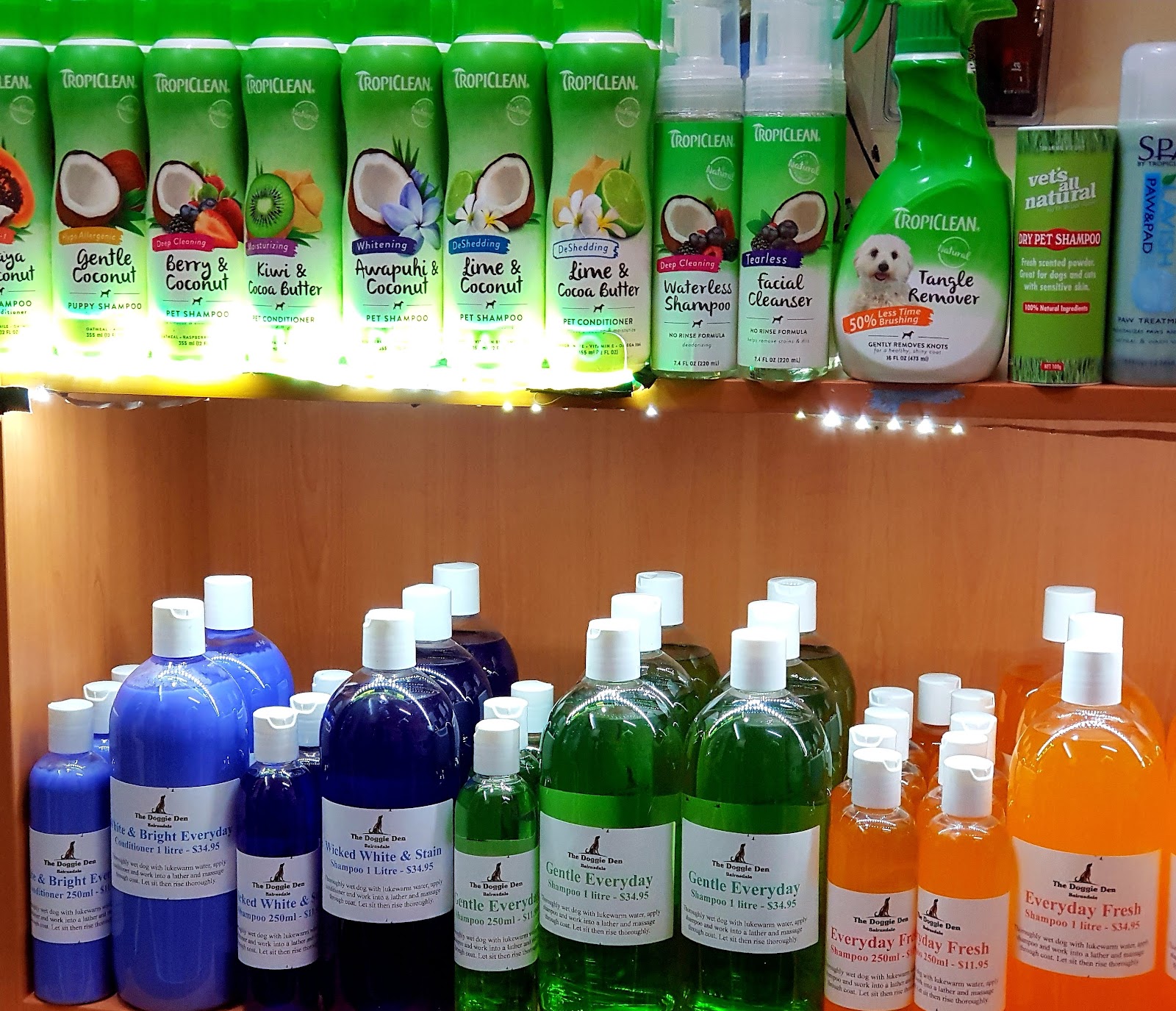 The Doggie Den’s own-label shampoos and conditioners in blue, green and orange bottles